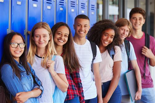 Group of Students Standing in Front of a row of school lockers 